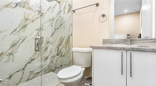 full bath with vanity, toilet, and a marble finish shower