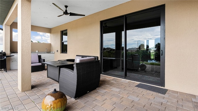 view of patio with outdoor lounge area and ceiling fan