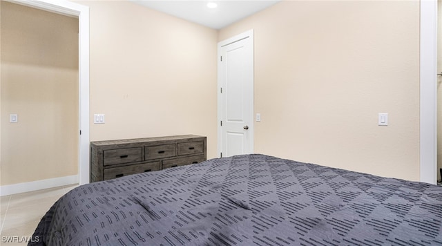 unfurnished bedroom with tile patterned flooring and baseboards