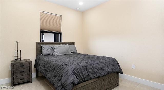 bedroom featuring light tile patterned floors and baseboards