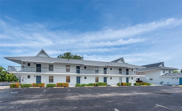 view of property featuring uncovered parking