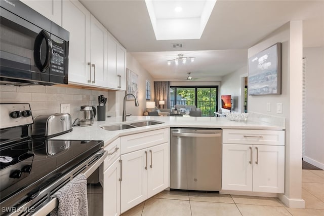 kitchen featuring a sink, tasteful backsplash, stainless steel appliances, light countertops, and light tile patterned floors