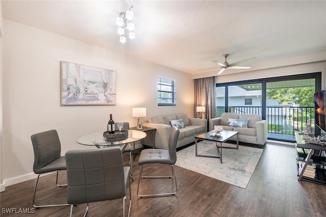 living area with baseboards, dark wood-style flooring, and ceiling fan