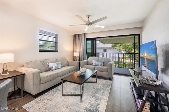 living area with a wealth of natural light, wood finished floors, and a ceiling fan