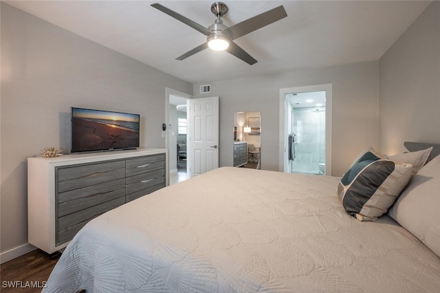 bedroom with visible vents, dark wood-type flooring, ceiling fan, baseboards, and ensuite bath