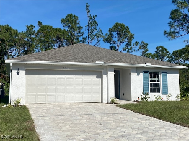 ranch-style home with a garage, stucco siding, decorative driveway, and roof with shingles