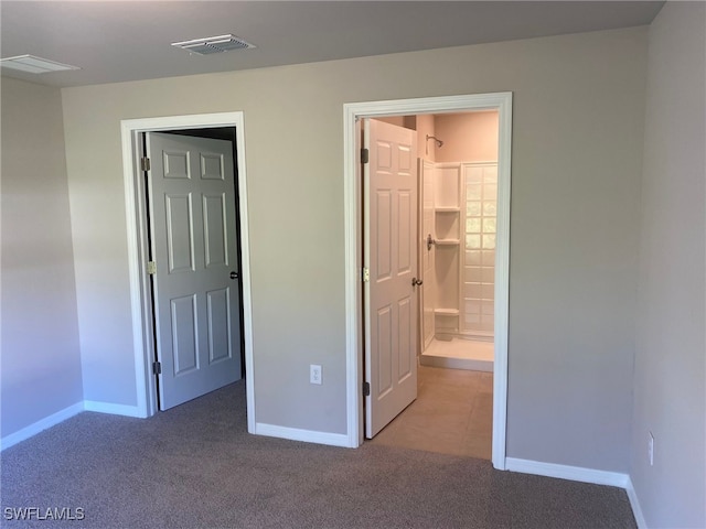 unfurnished bedroom with baseboards, visible vents, and carpet floors