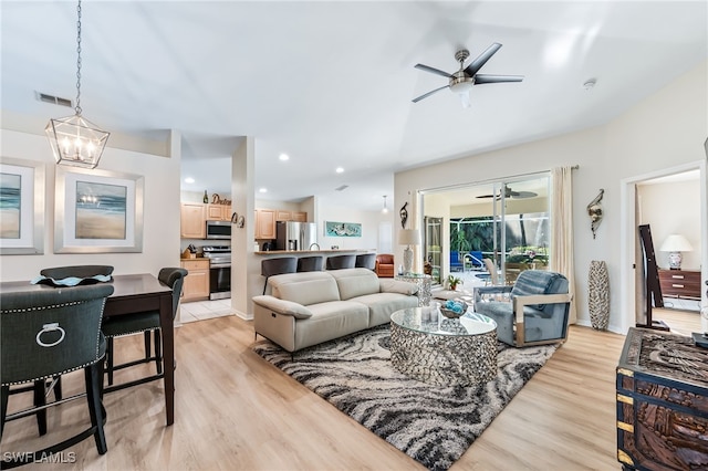 living room featuring recessed lighting, light wood-style flooring, visible vents, and ceiling fan