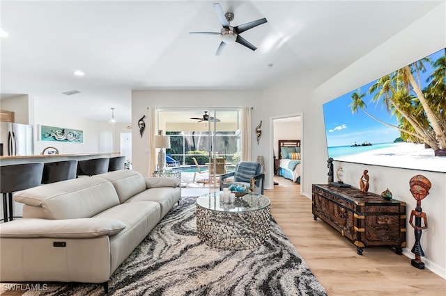 living room featuring visible vents, baseboards, recessed lighting, light wood-style floors, and a ceiling fan