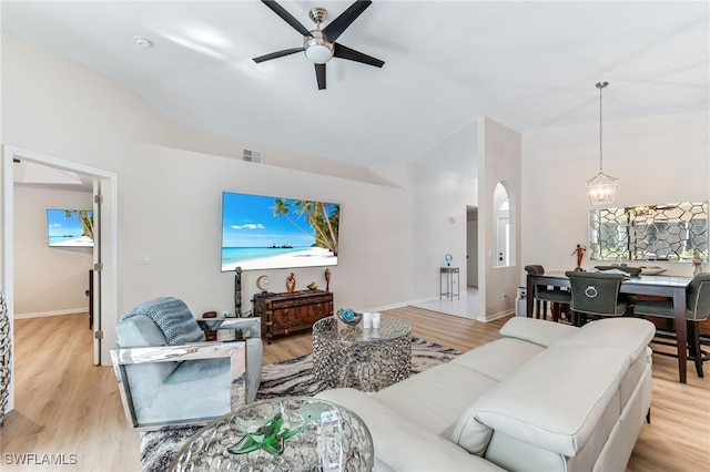 living room featuring a ceiling fan, visible vents, and light wood-type flooring