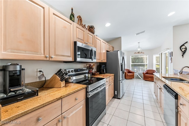 kitchen featuring light brown cabinets, visible vents, appliances with stainless steel finishes, and a sink