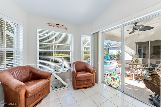 living area with tile patterned floors and a ceiling fan