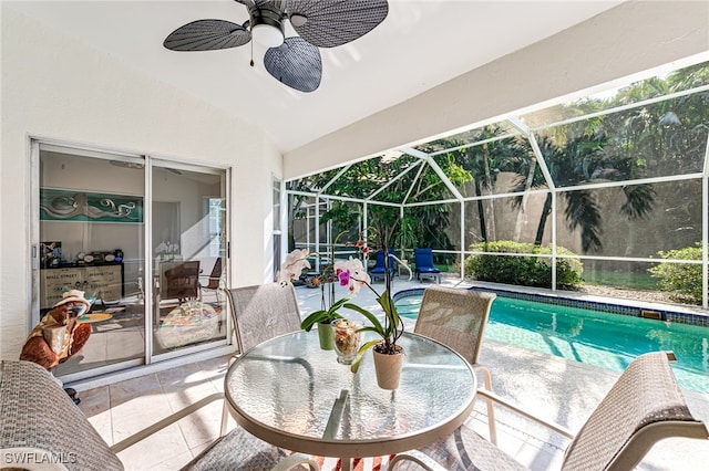 outdoor pool with a patio, a ceiling fan, and a lanai