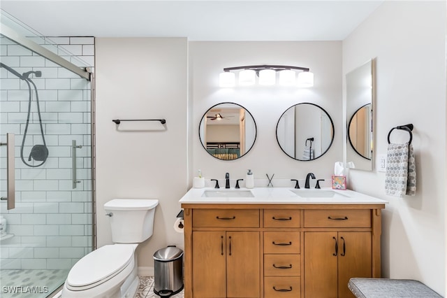 bathroom with a shower stall, toilet, double vanity, and a sink