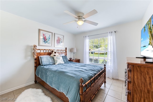 bedroom with baseboards, light tile patterned flooring, and a ceiling fan