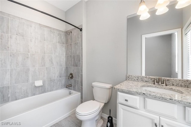 full bath featuring baseboards, toilet,  shower combination, and vanity