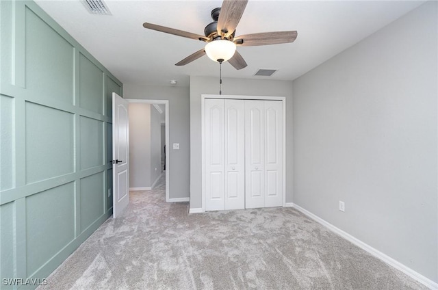 unfurnished bedroom with visible vents, baseboards, light colored carpet, and a closet
