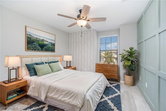 bedroom with light carpet and a ceiling fan