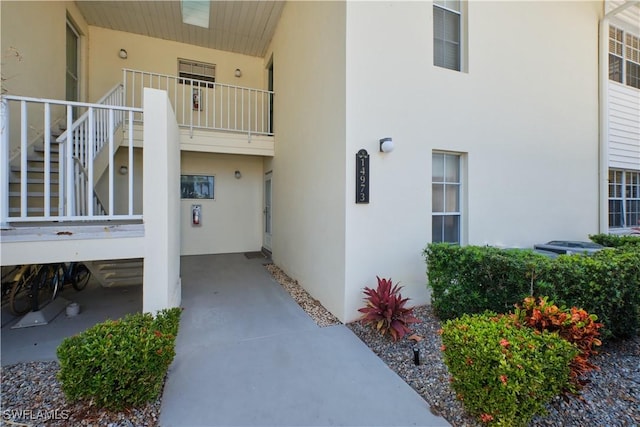 property entrance with stucco siding