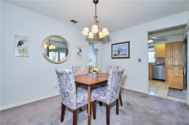 dining space featuring visible vents, light colored carpet, a textured ceiling, and baseboards