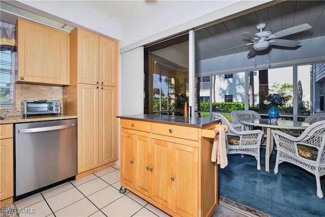 kitchen with light brown cabinets, a ceiling fan, a toaster, dishwasher, and tasteful backsplash