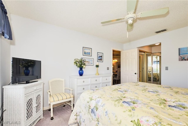 bedroom with carpet, visible vents, a closet, and ceiling fan