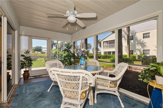 sunroom with wood ceiling and a ceiling fan