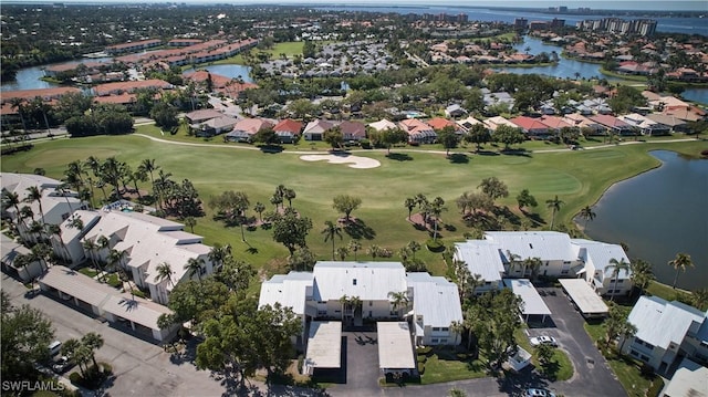 birds eye view of property with view of golf course, a water view, and a residential view