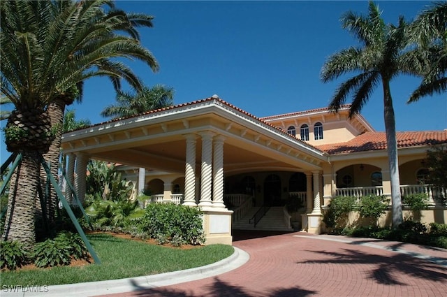 exterior space with a tile roof and decorative driveway