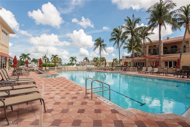 pool featuring a hot tub and a patio area
