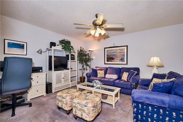 living area featuring carpet flooring, a textured ceiling, and a ceiling fan