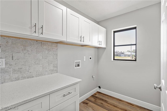 clothes washing area featuring hookup for a washing machine, wood finished floors, baseboards, cabinet space, and electric dryer hookup