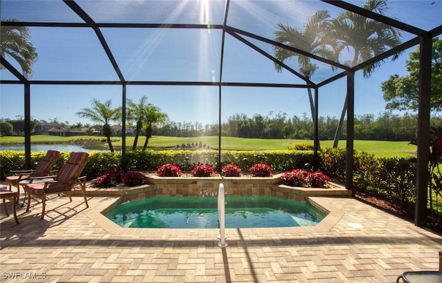 view of pool featuring glass enclosure, a patio, and a water view