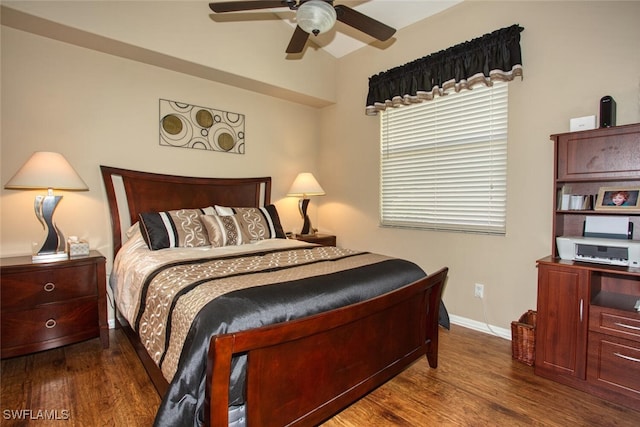 bedroom featuring ceiling fan, baseboards, and wood finished floors