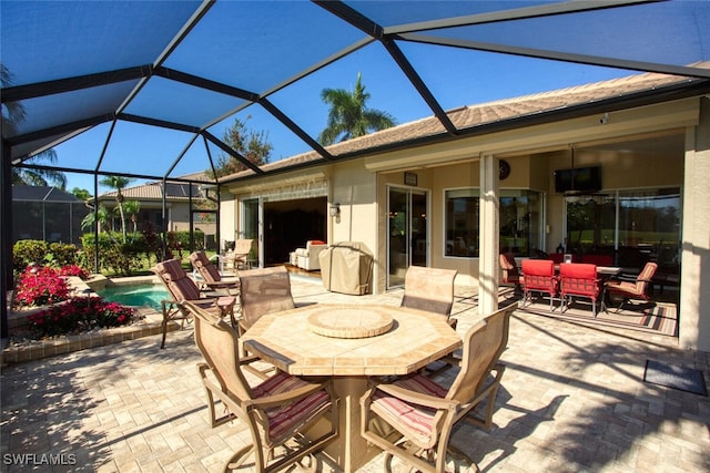 view of patio with outdoor dining space and an outdoor pool