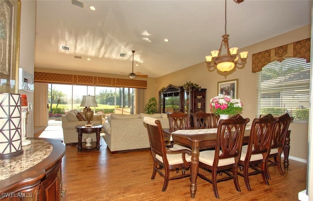 dining space featuring wood finished floors, visible vents, lofted ceiling, recessed lighting, and ceiling fan with notable chandelier