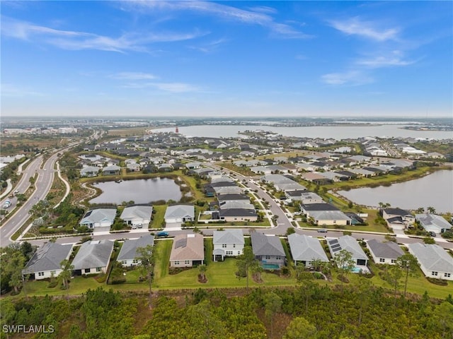 birds eye view of property featuring a residential view and a water view