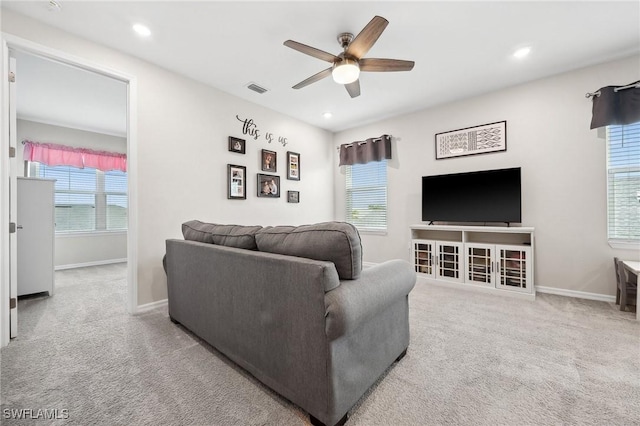 living room with carpet flooring, a healthy amount of sunlight, and visible vents