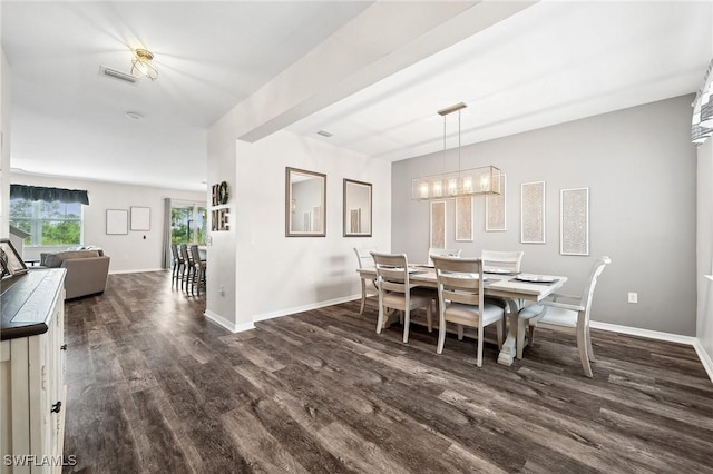 dining space with a notable chandelier, baseboards, dark wood-type flooring, and visible vents