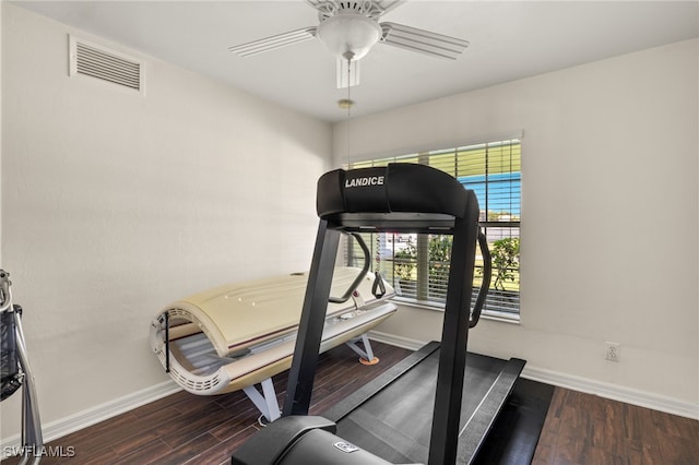 exercise room featuring visible vents, baseboards, wood finished floors, and a ceiling fan