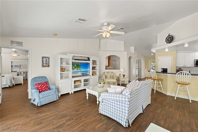 living room featuring visible vents, wood finished floors, a ceiling fan, and vaulted ceiling