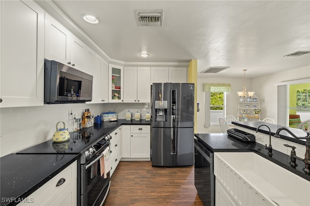 kitchen with a sink, stainless steel appliances, visible vents, and a wealth of natural light