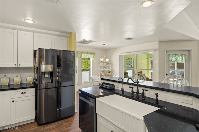 kitchen with tasteful backsplash, dark wood finished floors, black fridge with ice dispenser, white cabinets, and a sink