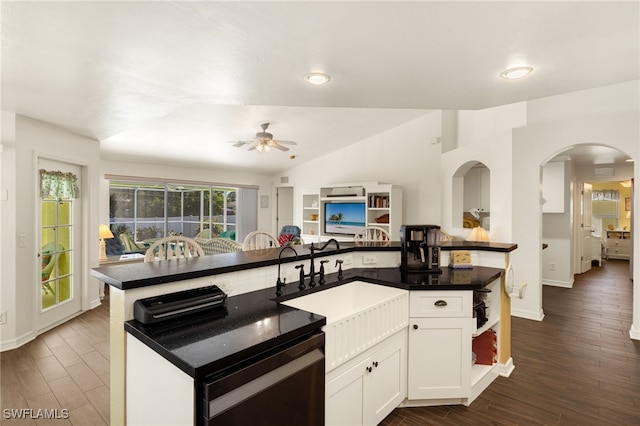 kitchen with a ceiling fan, dark wood-style floors, white cabinetry, arched walkways, and vaulted ceiling