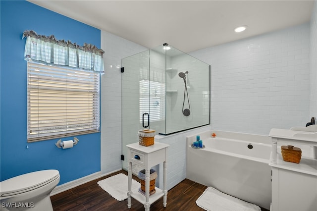 bathroom featuring tiled shower, a garden tub, wood tiled floor, and toilet