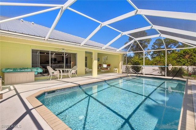 outdoor pool with a lanai and a patio area