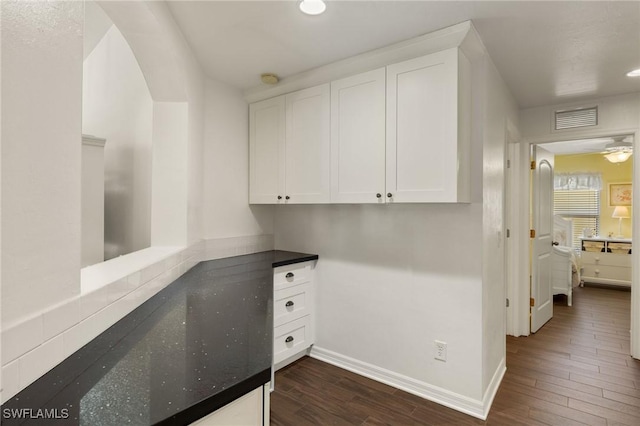 interior space with recessed lighting, visible vents, baseboards, and dark wood finished floors