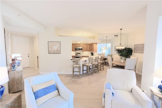 living room with baseboards and light wood finished floors