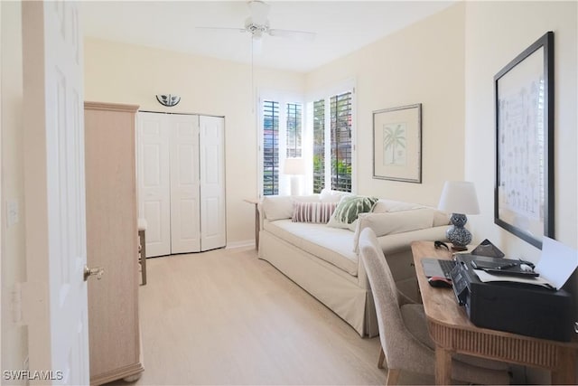 bedroom featuring a ceiling fan, wood finished floors, and a closet