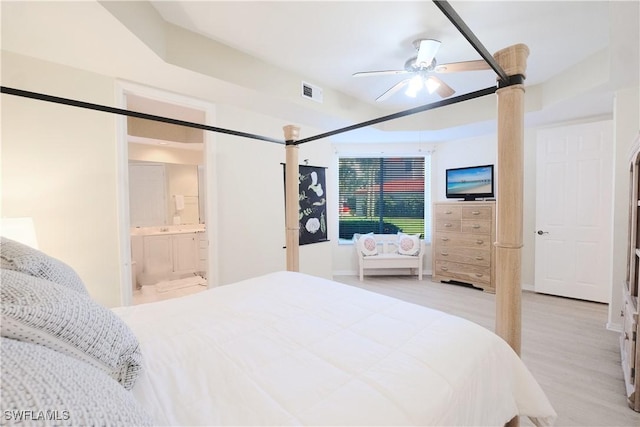 bedroom featuring a ceiling fan, light wood-type flooring, connected bathroom, and visible vents